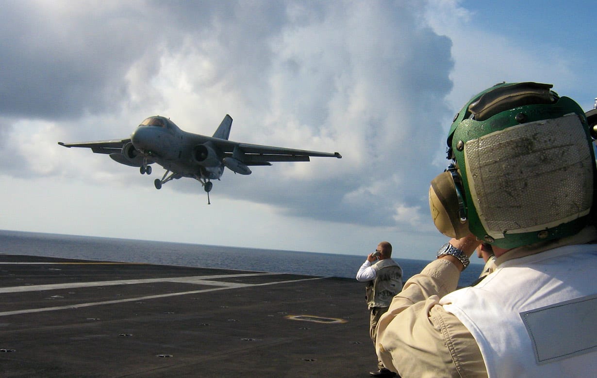 A fighter jet taking off from an aircraft carrier.