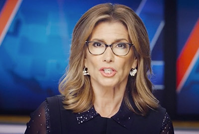 A woman with glasses is on the news.