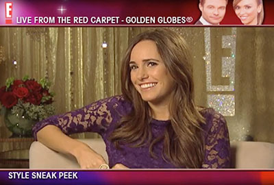 A woman in purple dress sitting on top of a couch.