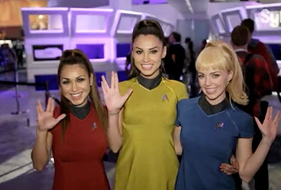 Three women in star trek uniforms posing for a picture.